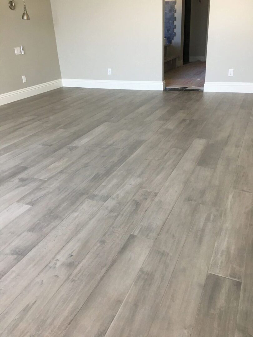 A grey flooring job in an empty room